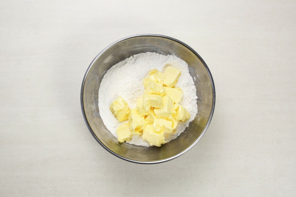 step 2 cubes of butter in flour in bowl