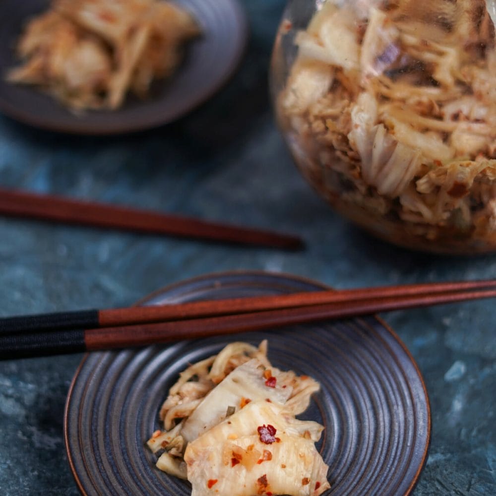 kimchi with chopsticks on plate