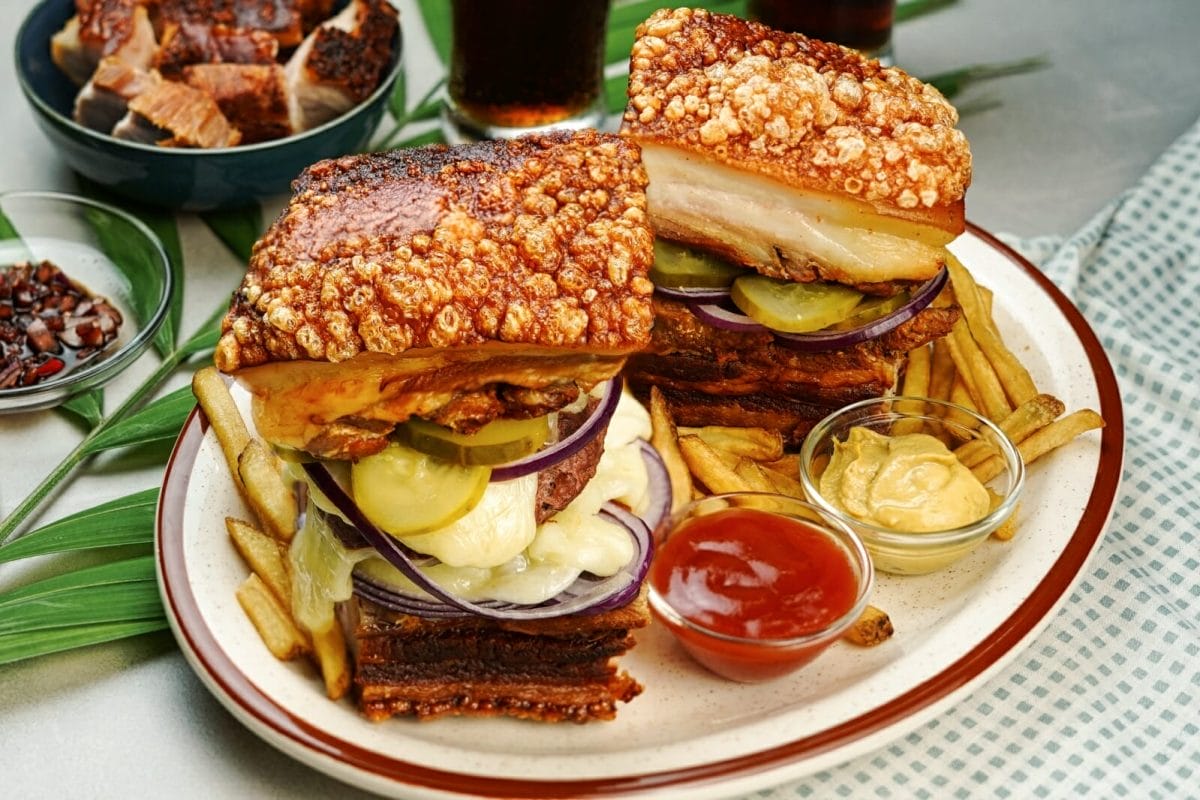 lechon burger with pickles beef patty onion